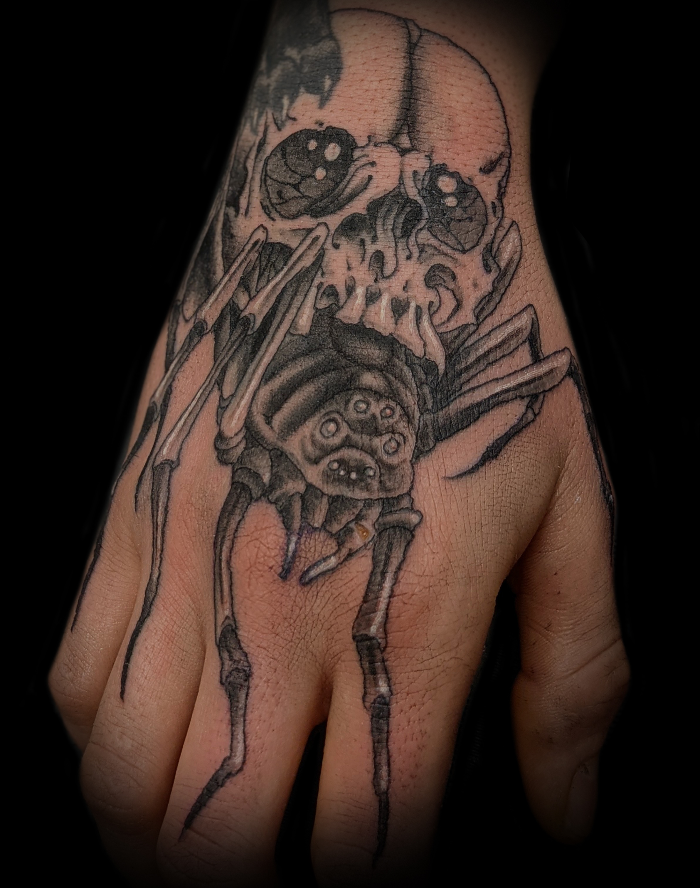 Spider skull hand tattoo